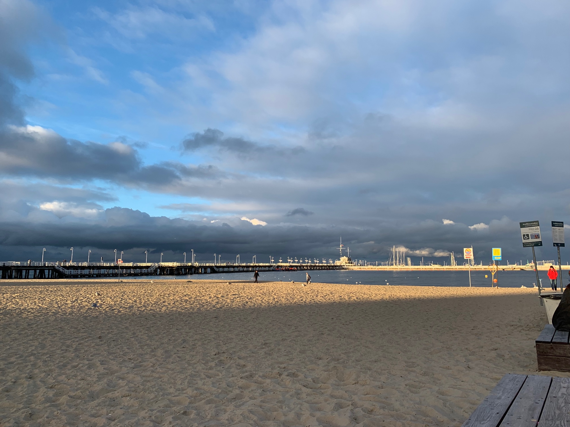 Panoramic view of Sopot pier - the longest wooden pier in Europe stretching into the Baltic under dramatic clouds
