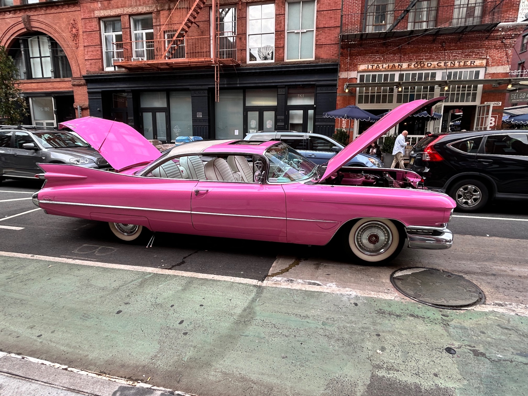 Vintage pink Cadillac in Little Italy - classic American style meets New York street charm