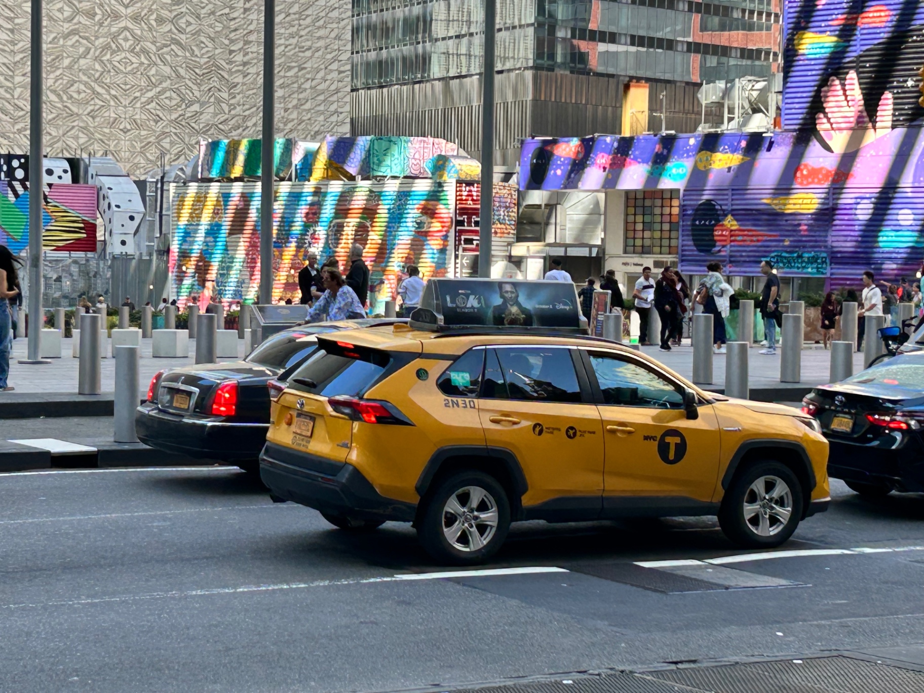 Yellow taxi in Times Square - the quintessential New York scene with colorful billboards