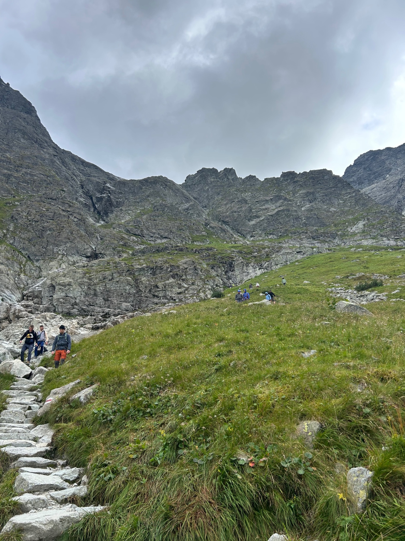 Hiking the stone steps along the mountain trail - fellow adventurers conquering the alpine terrain